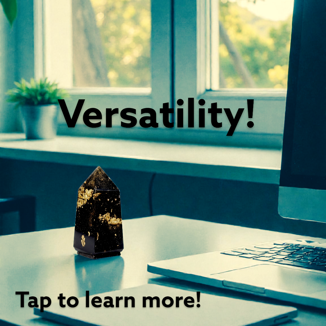 Desk with laptop, notebook, and orgonite on a windowsill with 'Versatility!' text.