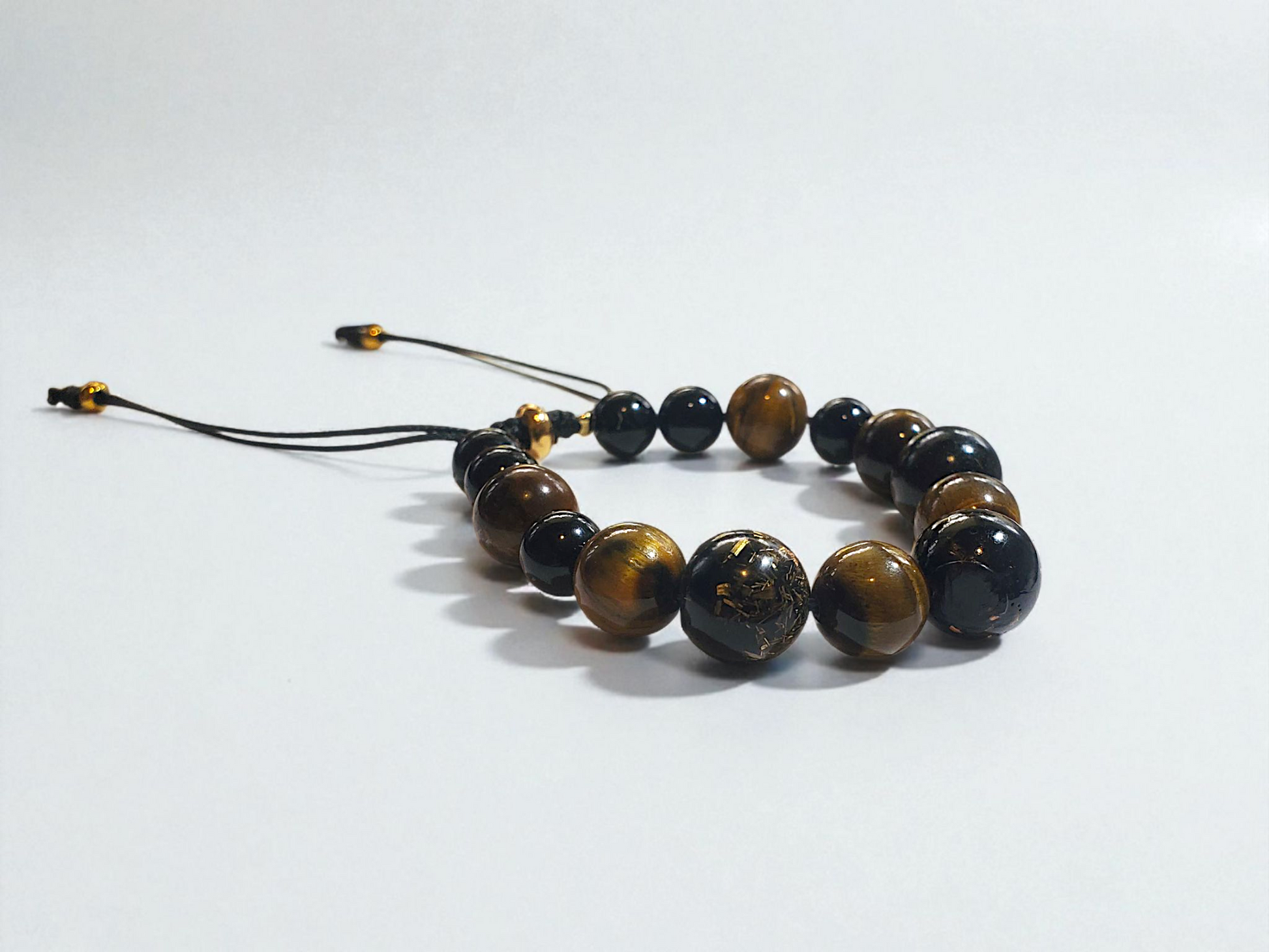 Bracelet with orgonites beads on a white background